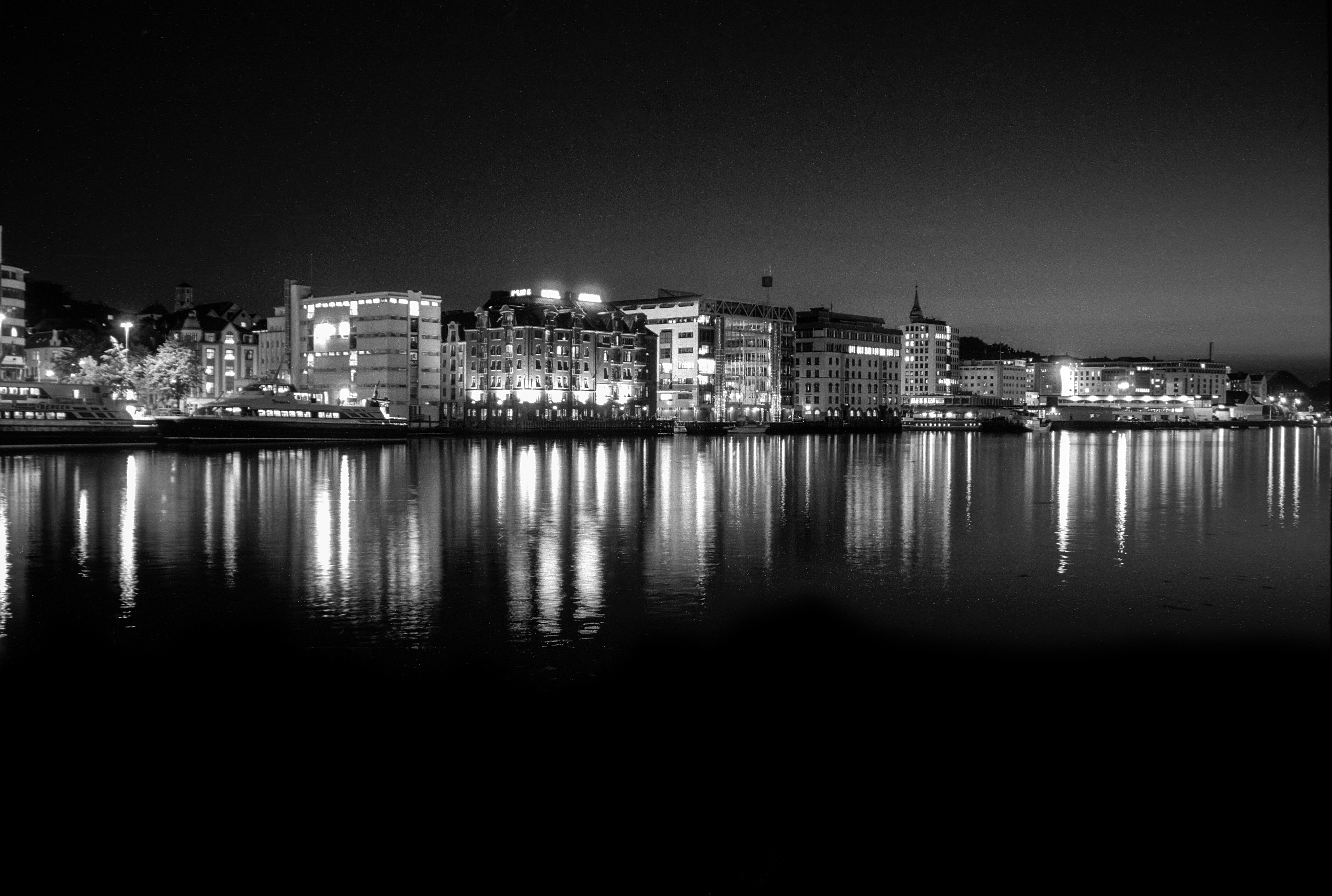 grayscale photo of city skyline during night time